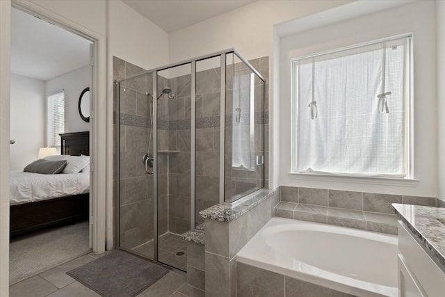 bathroom featuring a garden tub, ensuite bathroom, a stall shower, vanity, and tile patterned floors