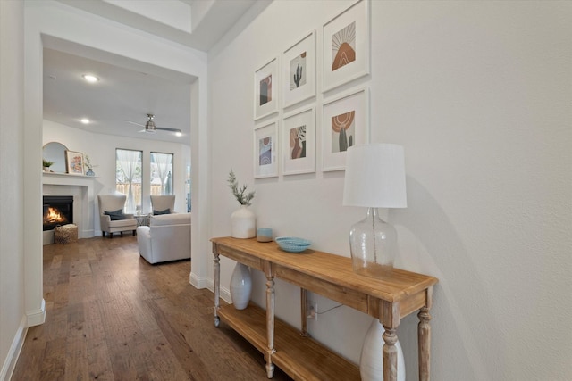 hallway with recessed lighting, baseboards, and wood finished floors