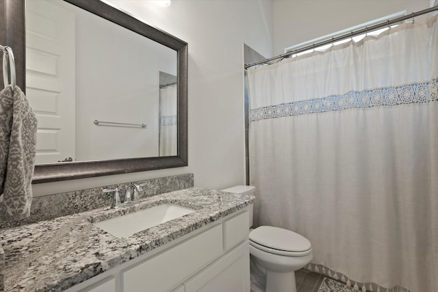 full bathroom with vanity and toilet