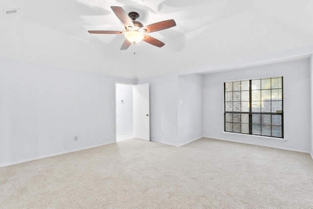 carpeted empty room featuring ceiling fan, visible vents, and baseboards