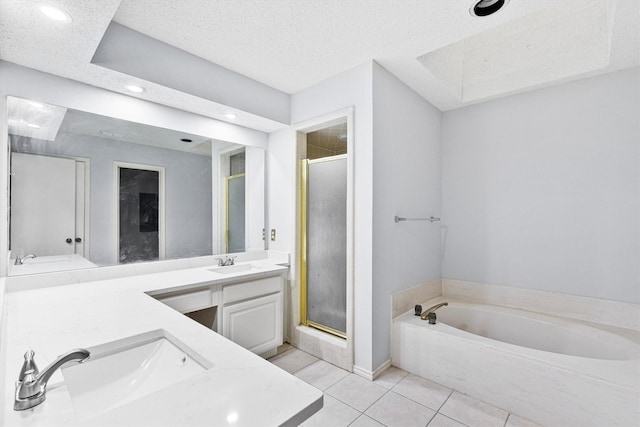 full bathroom with a stall shower, double vanity, a sink, and tile patterned floors