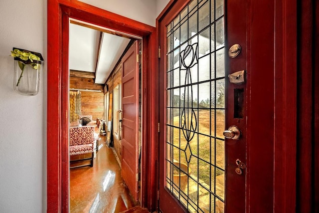 entryway featuring wood walls