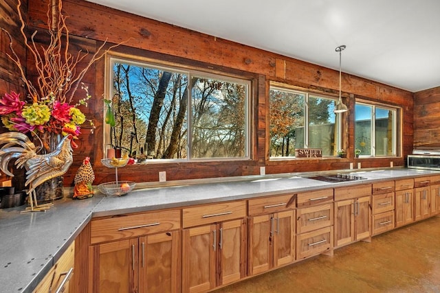 kitchen with cooktop, light countertops, and decorative light fixtures