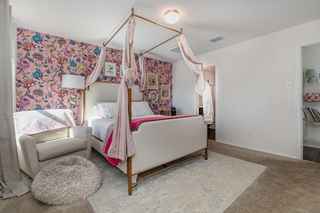 bedroom featuring carpet floors, visible vents, and baseboards