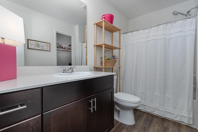 full bath featuring a shower with curtain, vanity, toilet, and wood finished floors