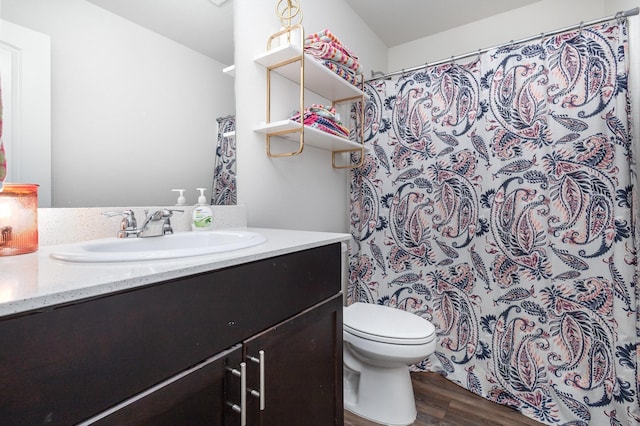 full bathroom with curtained shower, vanity, toilet, and wood finished floors