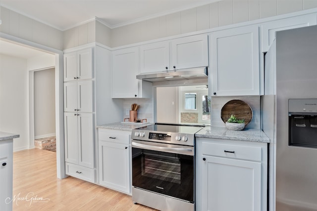 kitchen with under cabinet range hood, white cabinets, appliances with stainless steel finishes, light wood finished floors, and crown molding