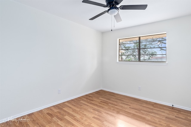 spare room featuring light wood-style floors, ceiling fan, and baseboards