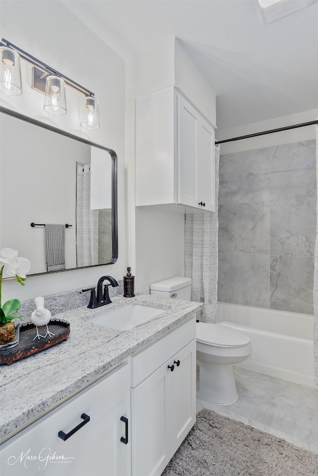 bathroom with toilet, marble finish floor, shower / tub combo, and vanity