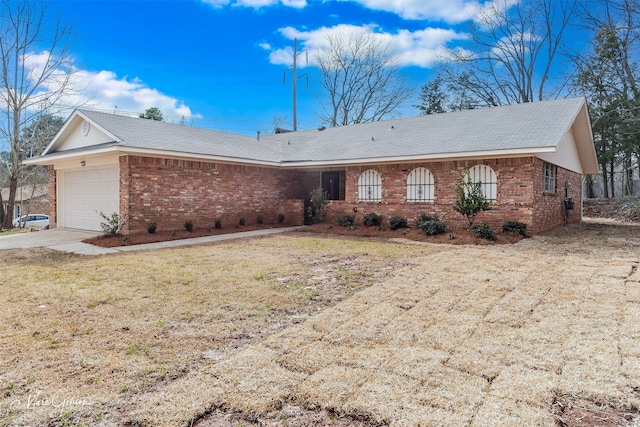 single story home with an attached garage, a front yard, concrete driveway, and brick siding