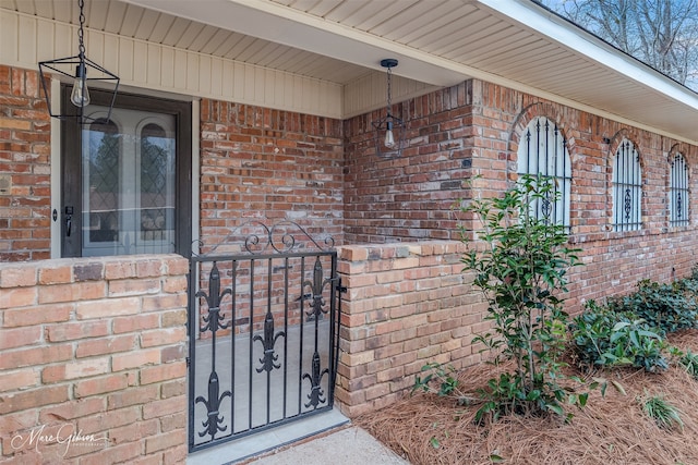 property entrance with brick siding and a gate