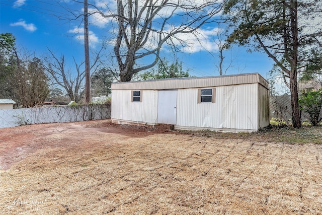 view of outdoor structure with an outbuilding and fence