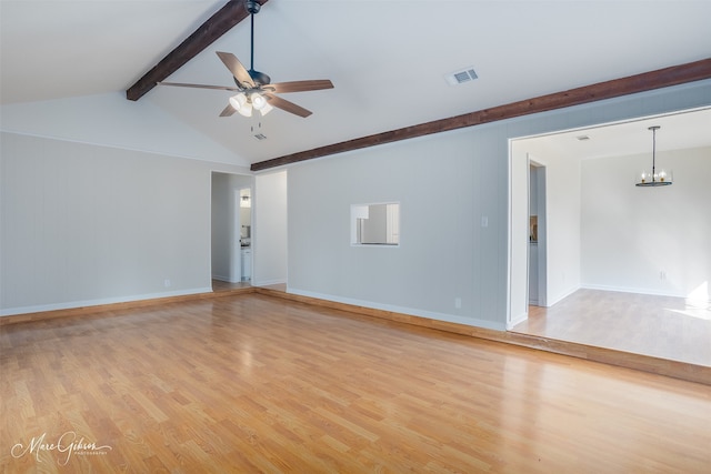 empty room with visible vents, baseboards, lofted ceiling with beams, light wood-style flooring, and ceiling fan with notable chandelier