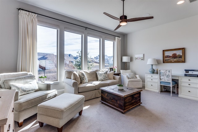 living area featuring recessed lighting, visible vents, light carpet, ceiling fan, and baseboards