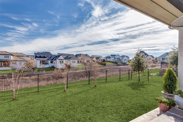 view of yard with fence and a residential view