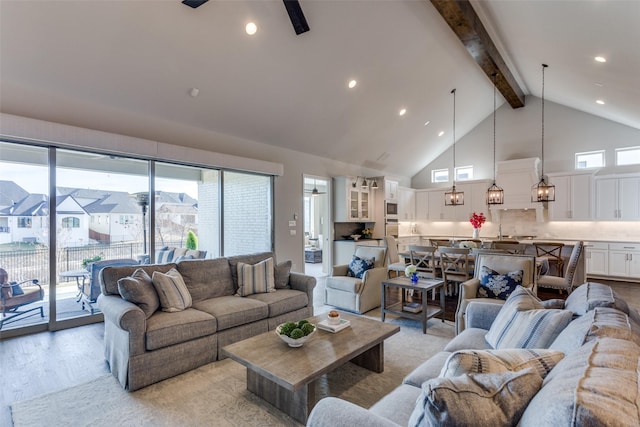 living room with ceiling fan, light wood-style floors, high vaulted ceiling, beam ceiling, and recessed lighting