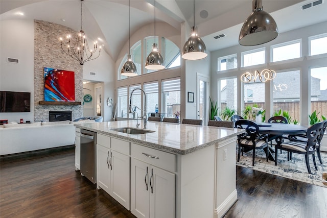 kitchen featuring dark wood-type flooring, plenty of natural light, visible vents, and a sink