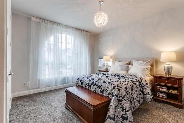 bedroom with carpet, a notable chandelier, and baseboards