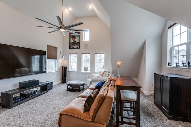 living room featuring ceiling fan, dark colored carpet, high vaulted ceiling, and baseboards