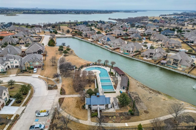 birds eye view of property with a residential view and a water view