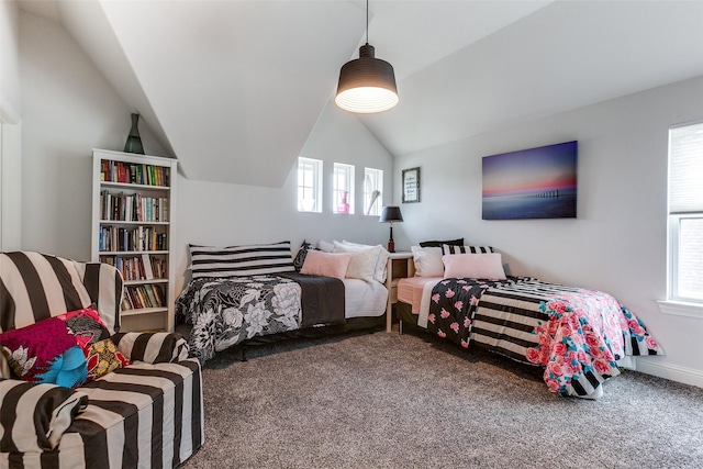 carpeted bedroom featuring vaulted ceiling and baseboards