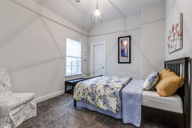 carpeted bedroom featuring visible vents, baseboards, and vaulted ceiling