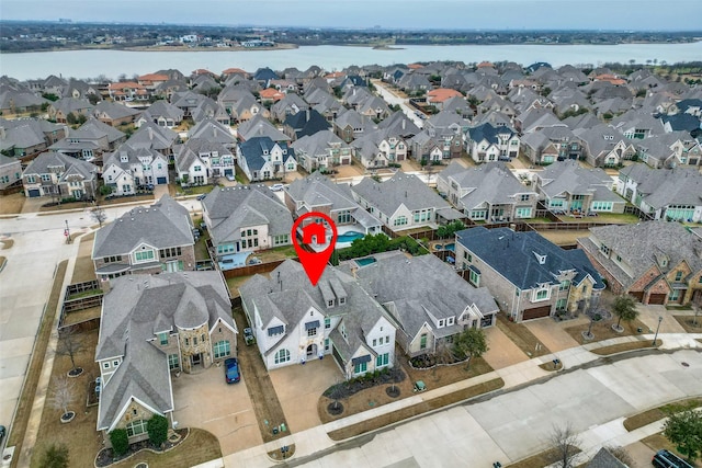 bird's eye view featuring a water view and a residential view