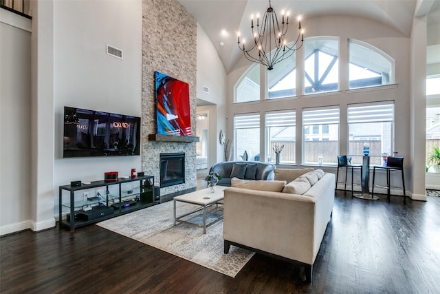 living area featuring high vaulted ceiling, dark wood-style flooring, a fireplace, visible vents, and baseboards