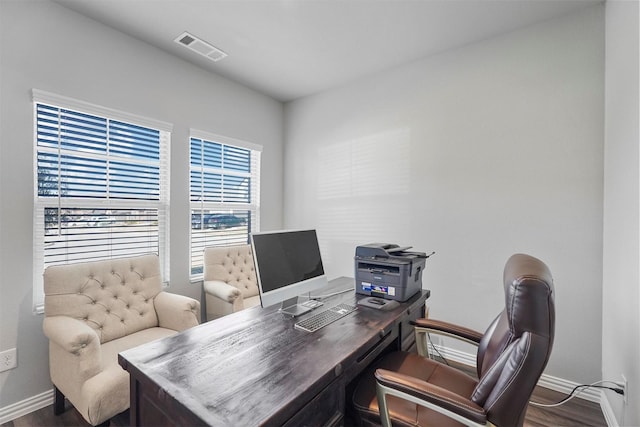 office space with visible vents, baseboards, and wood finished floors