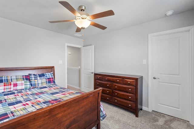 bedroom with a ceiling fan, light colored carpet, visible vents, and baseboards