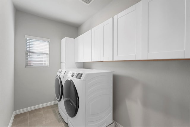 clothes washing area featuring light tile patterned floors, cabinet space, visible vents, independent washer and dryer, and baseboards