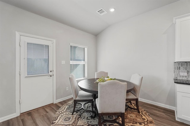 dining room featuring lofted ceiling, recessed lighting, dark wood-style flooring, visible vents, and baseboards