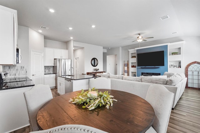 dining space featuring recessed lighting, visible vents, ceiling fan, and wood finished floors