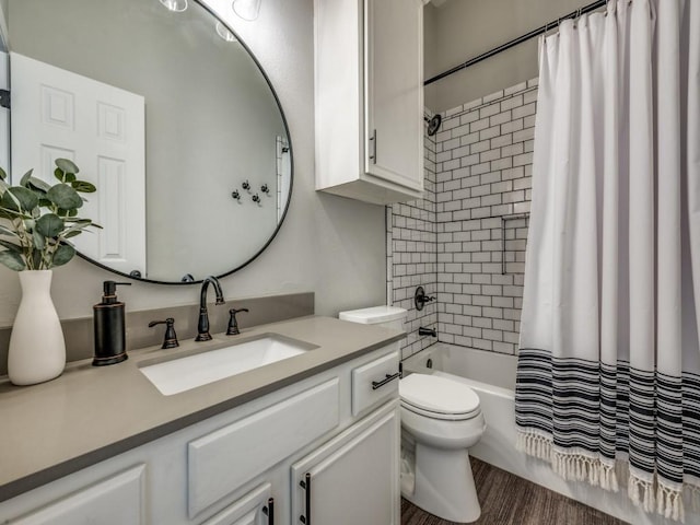 full bath featuring toilet, shower / bath combo with shower curtain, and vanity