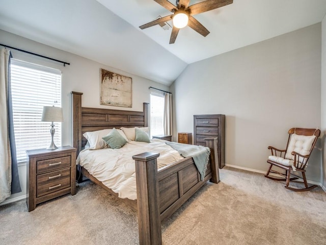 bedroom featuring light carpet, vaulted ceiling, a ceiling fan, and baseboards