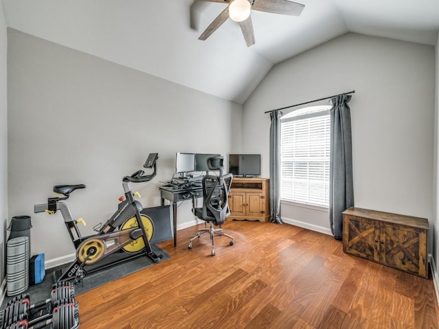 office featuring vaulted ceiling, light wood-style flooring, baseboards, and ceiling fan