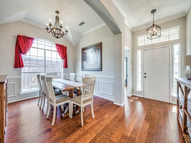 dining space with a chandelier, wood finished floors, and visible vents