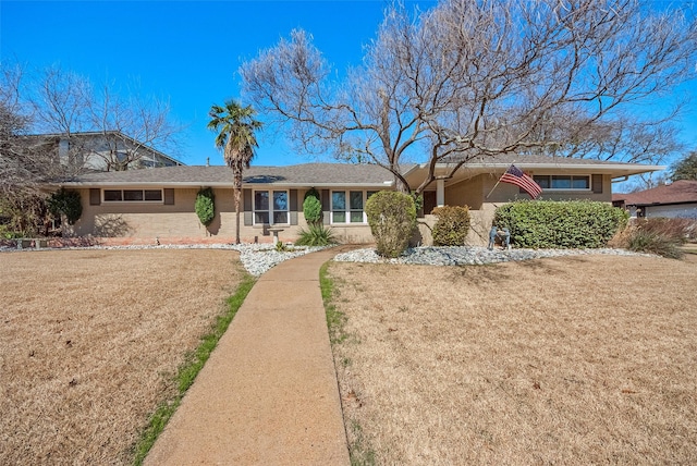 ranch-style home with a front yard