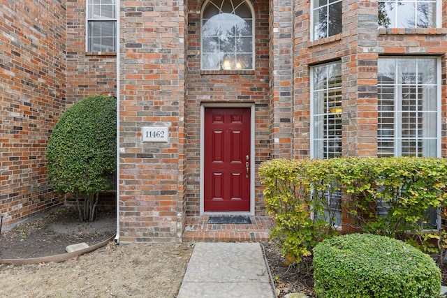 property entrance featuring brick siding