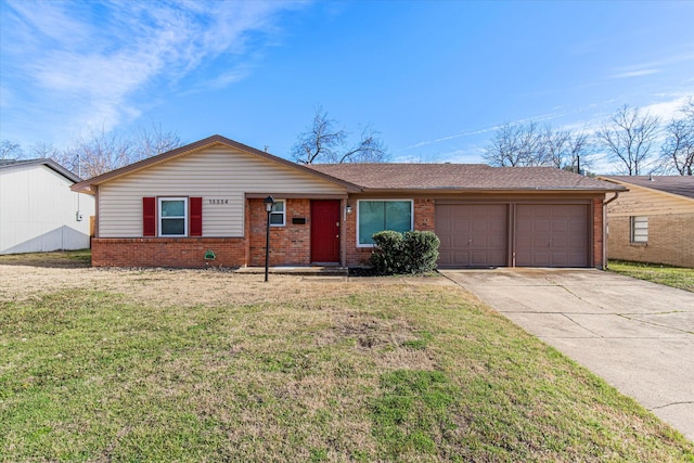 ranch-style home featuring a garage, driveway, brick siding, and a front lawn