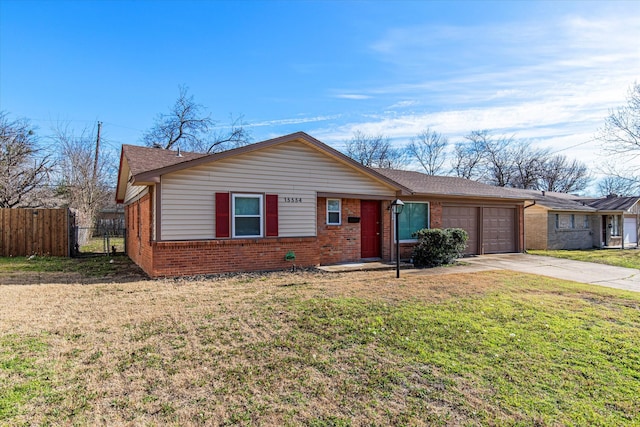 view of front facade featuring brick siding, fence, a garage, driveway, and a front lawn