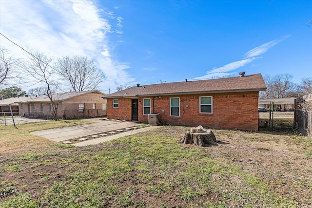 back of house featuring a fenced backyard, cooling unit, a yard, a patio area, and brick siding