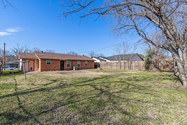 view of yard with a patio area, fence, and central AC unit