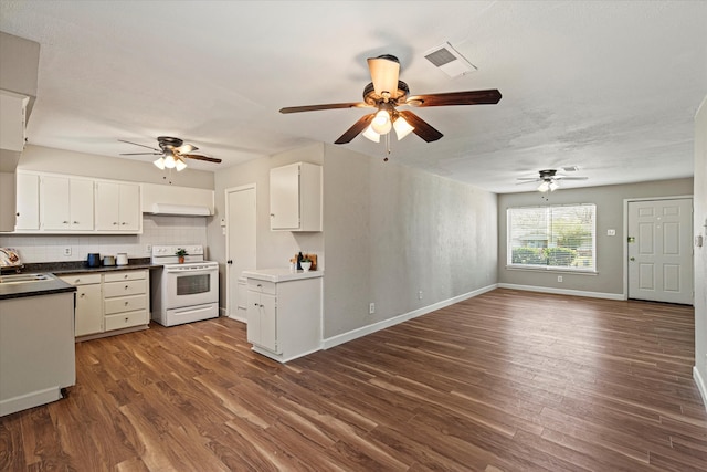 kitchen featuring white electric range oven, visible vents, dark wood-style flooring, and a sink