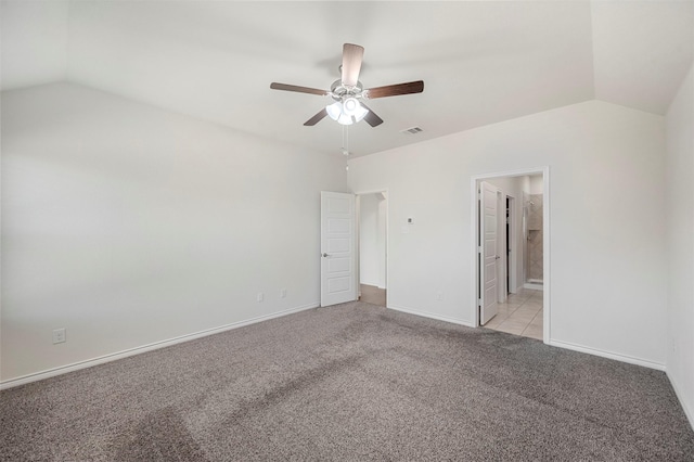 unfurnished bedroom featuring light carpet, lofted ceiling, visible vents, and baseboards