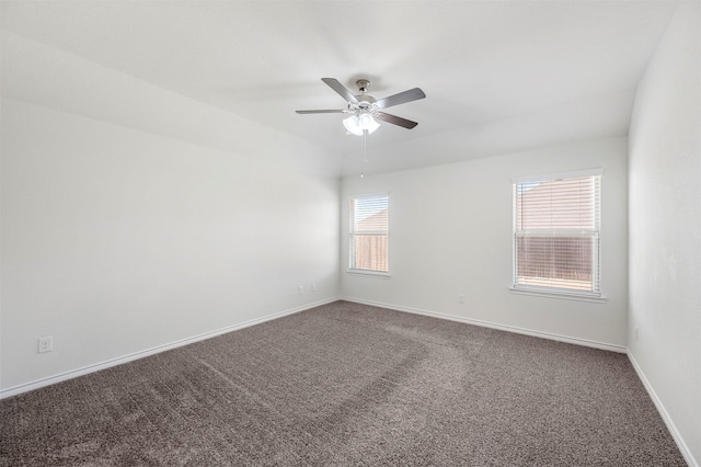 spare room with carpet flooring, ceiling fan, and baseboards