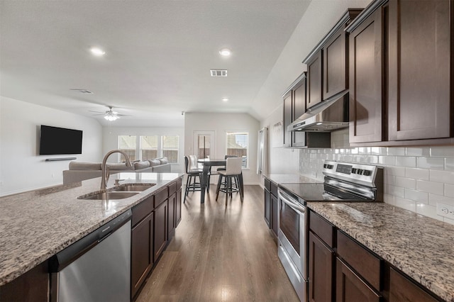 kitchen with dark brown cabinetry, visible vents, stainless steel appliances, under cabinet range hood, and a sink