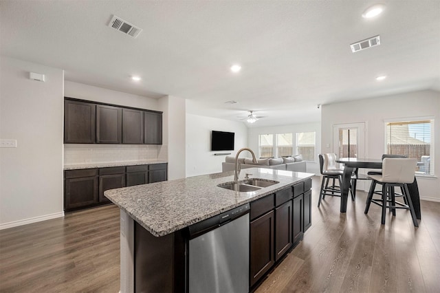 kitchen featuring a center island with sink, visible vents, a sink, and stainless steel dishwasher