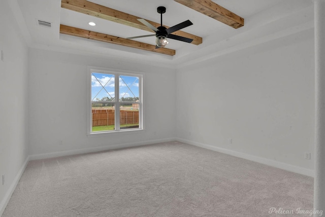 spare room with carpet floors, visible vents, beam ceiling, baseboards, and a ceiling fan