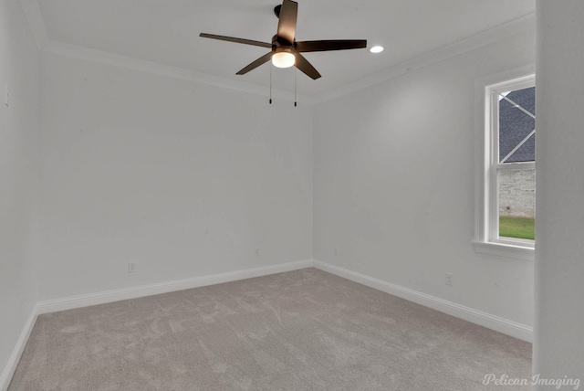 carpeted empty room featuring baseboards, crown molding, and ceiling fan